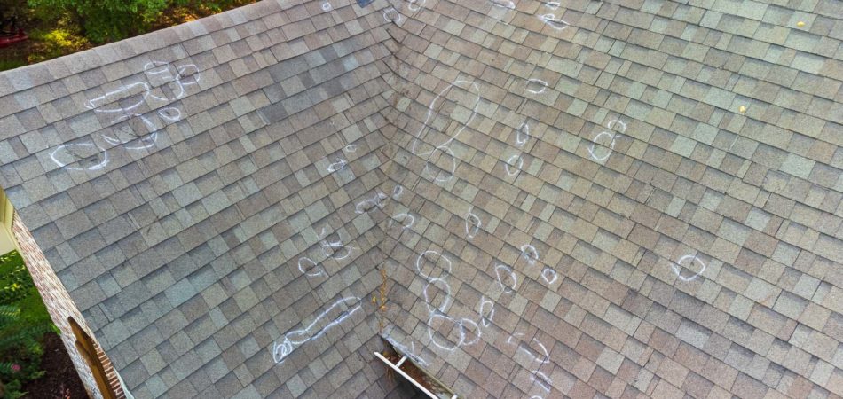 Roof with hail damage and chalk markings from inspection